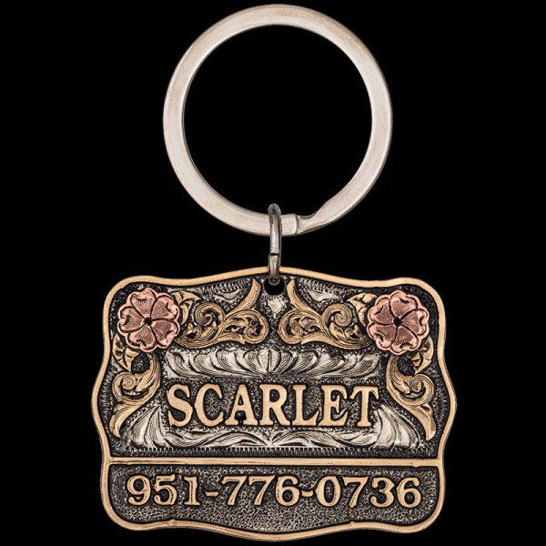 The Scarlet Custom Dog Tag is crafted with a German silver Base and adorned with jeweler's bronze edge, letters, and scrolls, accented by copper flowers. Order now!